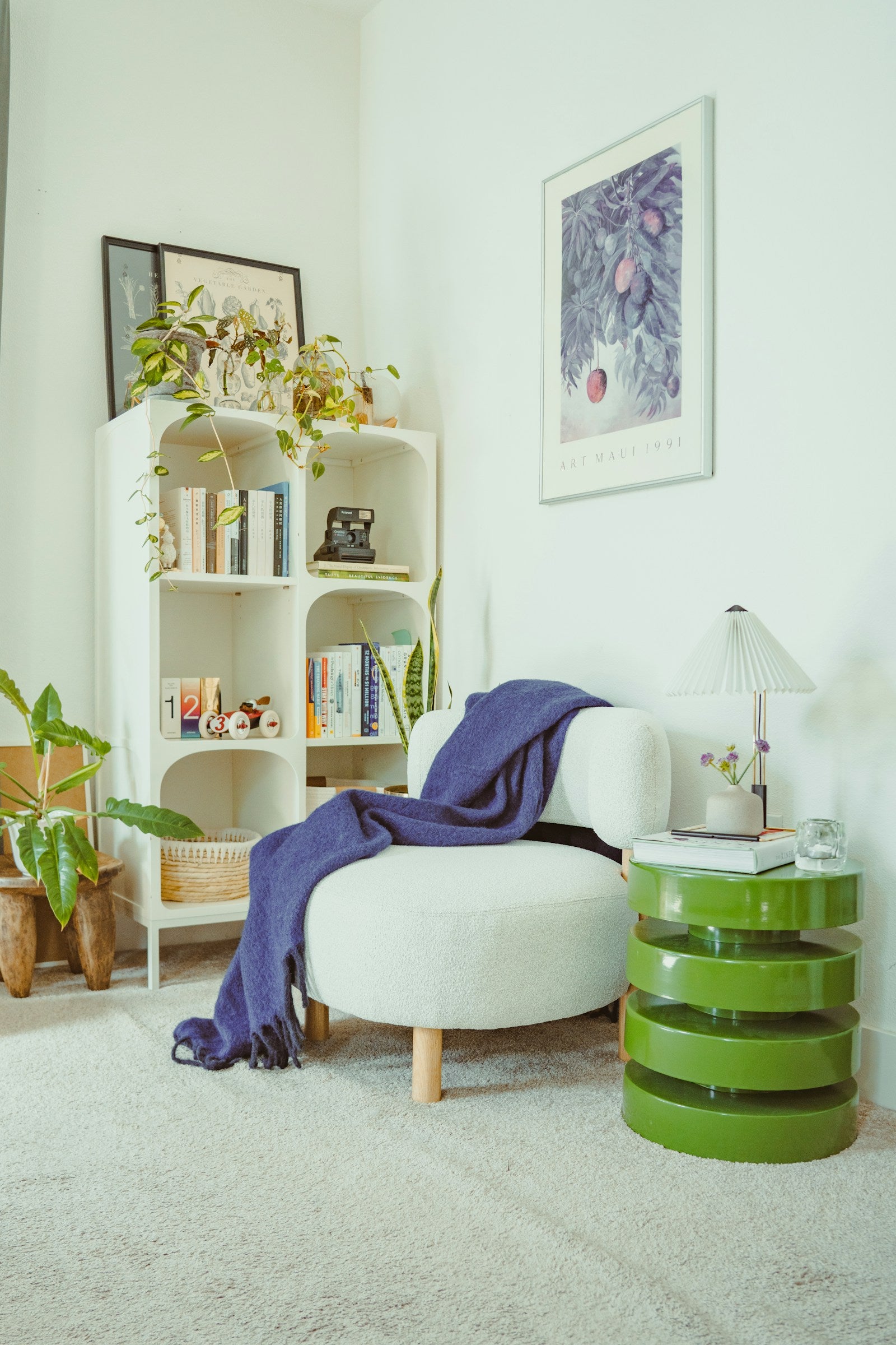 Bright reading corner with an armchair, throw and plants